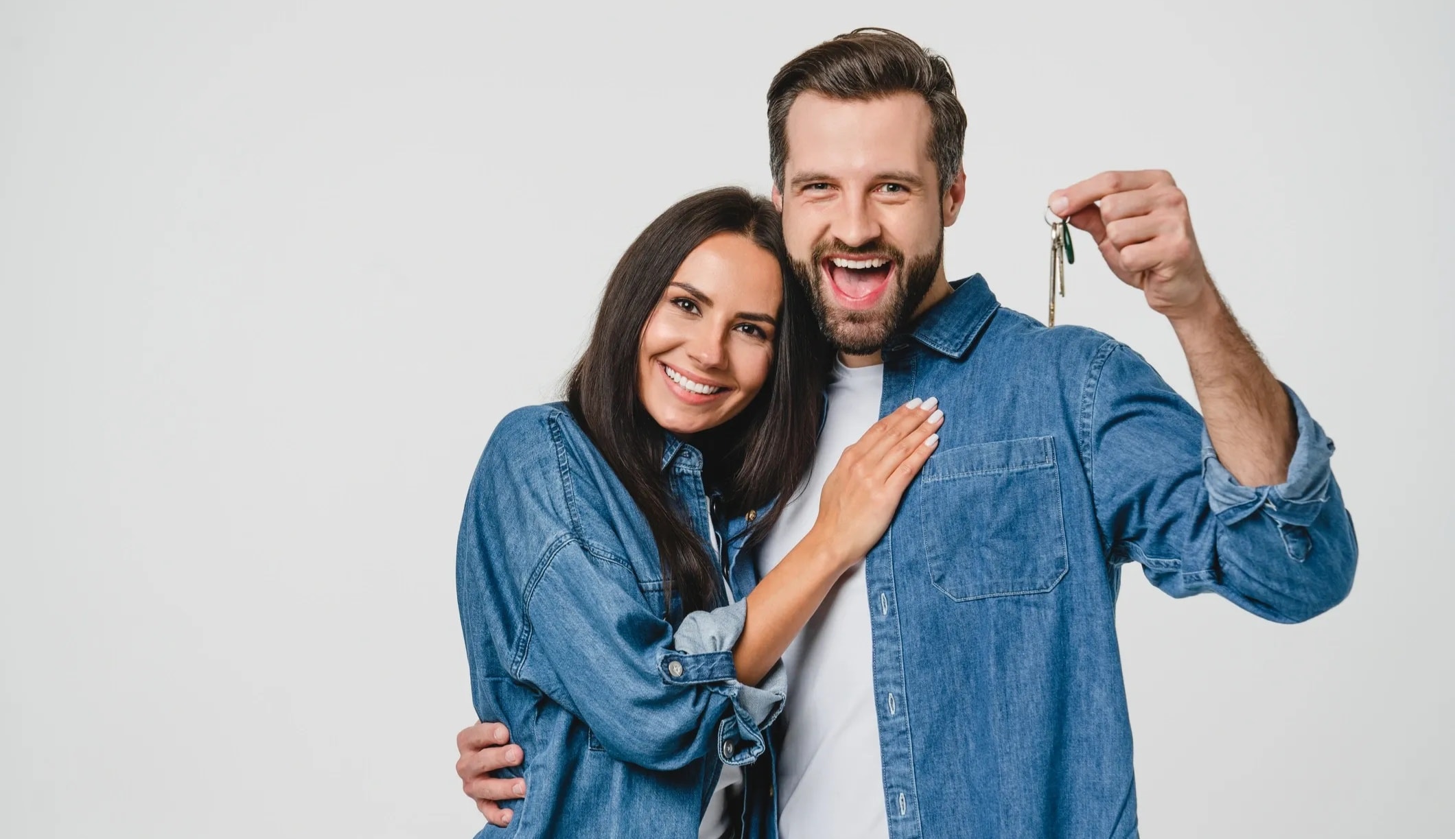 Happy couple receiving keys to their first home